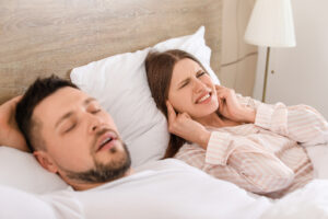 woman with partner who snores sleep apnea treatment concept